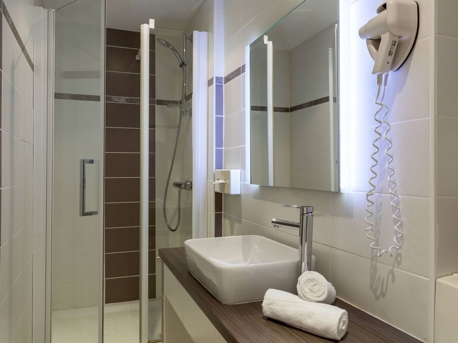 Bathroom vanity in bedrooms at Hotel Les Nations