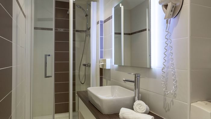 Bathroom vanity in bedrooms at Hotel Les Nations