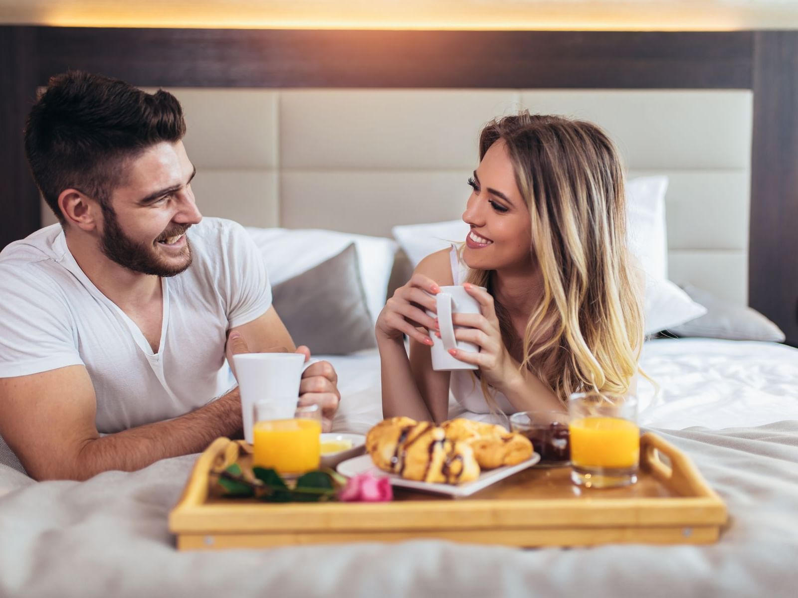 Couples having breakfast in bed