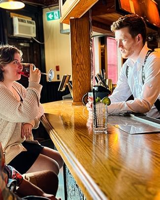 Bartender serving drinks in Dawson City, YK