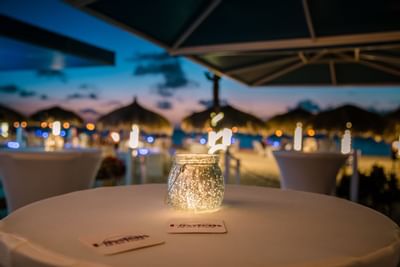 Burning candle on table in darkness at Amsterdam Manor Resort