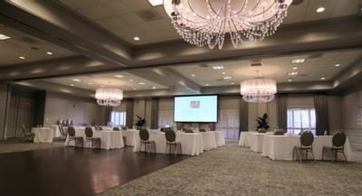 Ballroom with meeting set-up & screen at Ethan Allen Hotel
