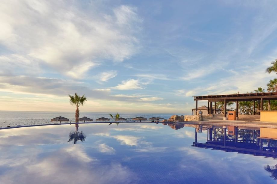 Outdoor pool area overlooking the ocean at Fiesta Americana Travelty