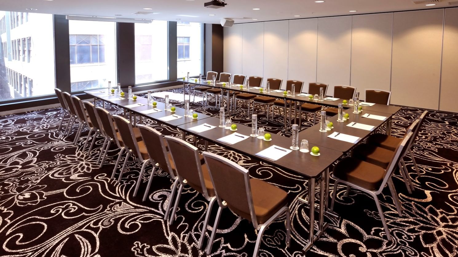 U-shaped table setup for event at Novotel Melbourne on Collins