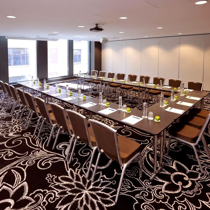 U-shaped table setup for event at Novotel Melbourne on Collins