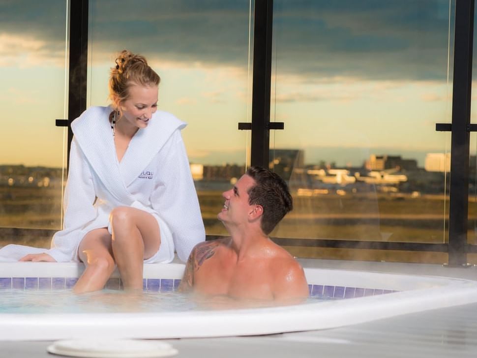 Couple in hot bath tubes at Applause Hotel Calgary