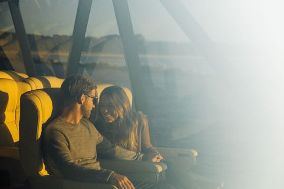 A couple looking at each other while smiling at Gordon River Cruise