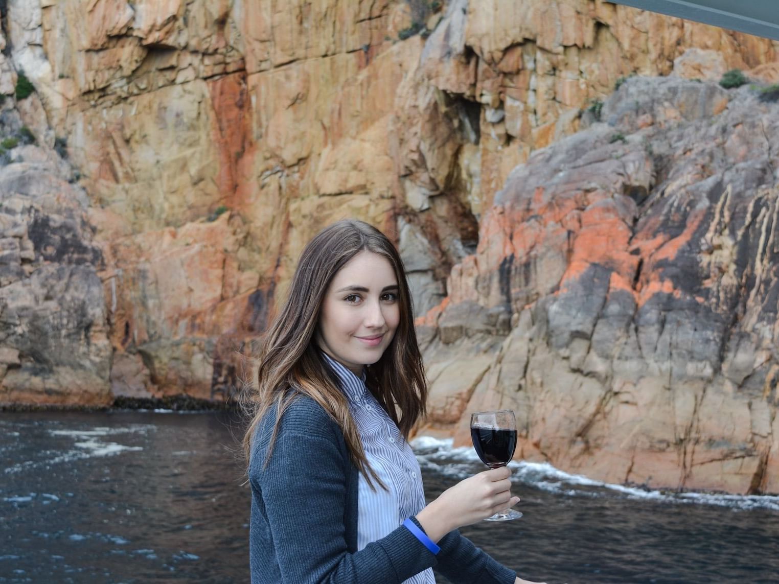 Lady with a wine glass near the Bay at Freycinet Lodge