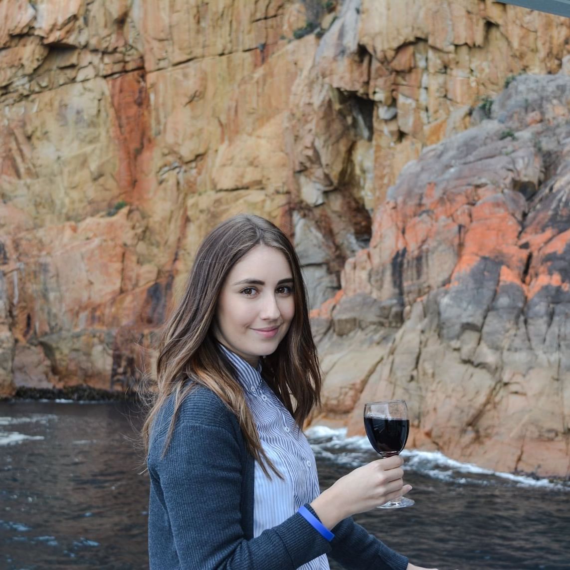 Lady with a wine glass near the Bay at Freycinet Lodge