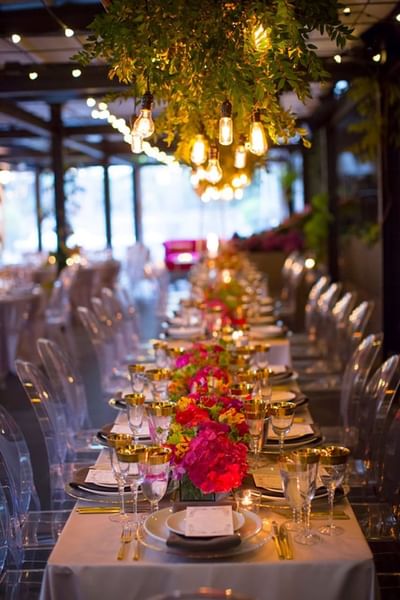 Floral dining tables arranged in Tony's at J House Greenwich, a boutique hotel in Greenwich for events and meetings