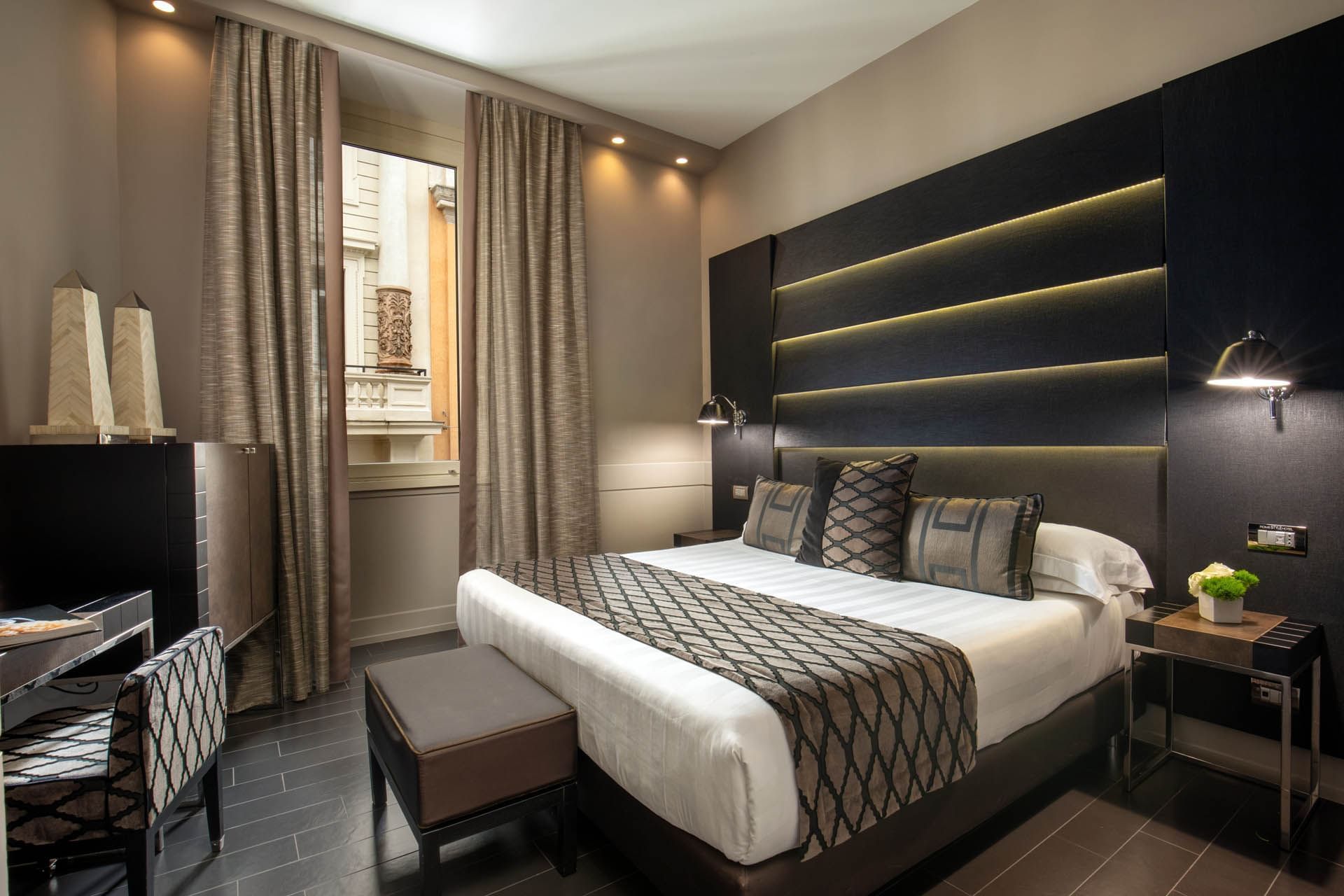 Interior of the Superior Room with a work desk by the king bed and window at The Style