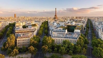 Aerial view of Paris showcasing ornate rooftops and the grand Palais Garnier opera house near Warwick Hotels & Resorts