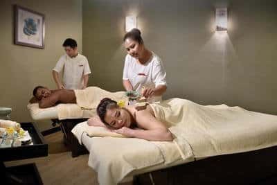 Professional spa therapists providing rejuvenating treatments to couple at LexSpa - Lexis Suites Penang