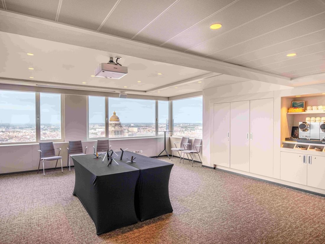 Meet 25 Three Meeting room with large windows offering a city view at The Hotel Brussels