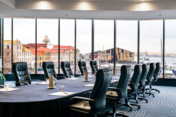 Conference style set-up with desk filled with note pads in Harbour View 2 at Grand Chancellor Hobart