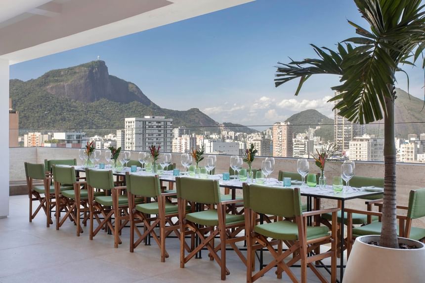 Rooftop dining & lounge area overlooking the city at Janeiro Hotel
