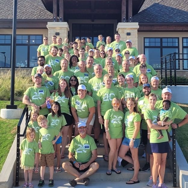 People gathered by the entrance stairway with team bonding shirts at Shangri-La Monkey Island