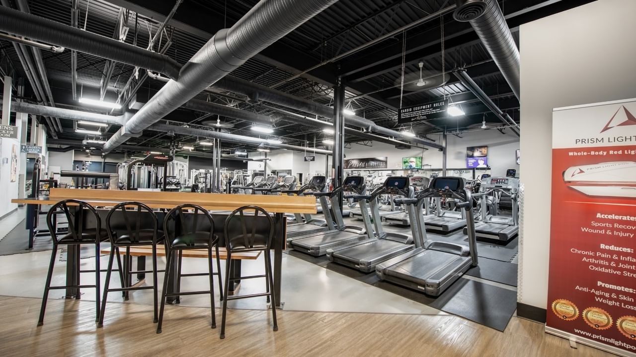 Gym interior with treadmills and workout equipment.