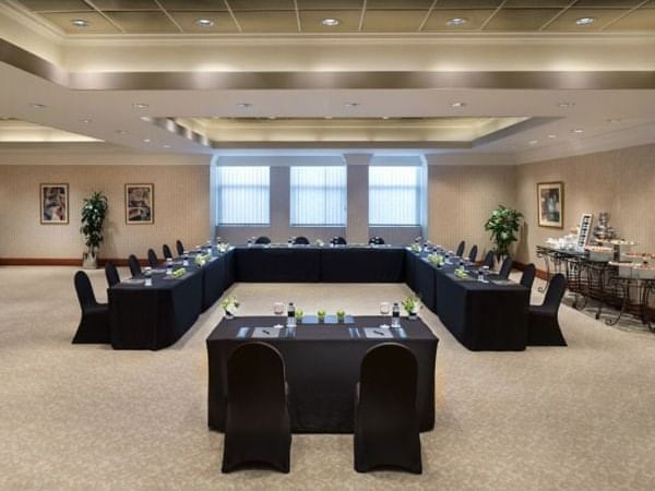 A U-shaped table in a meeting room at Ajman Hotel