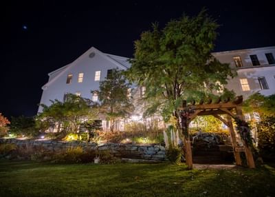 Garden area illuminated with warm lights at night in Harraseeket Inn