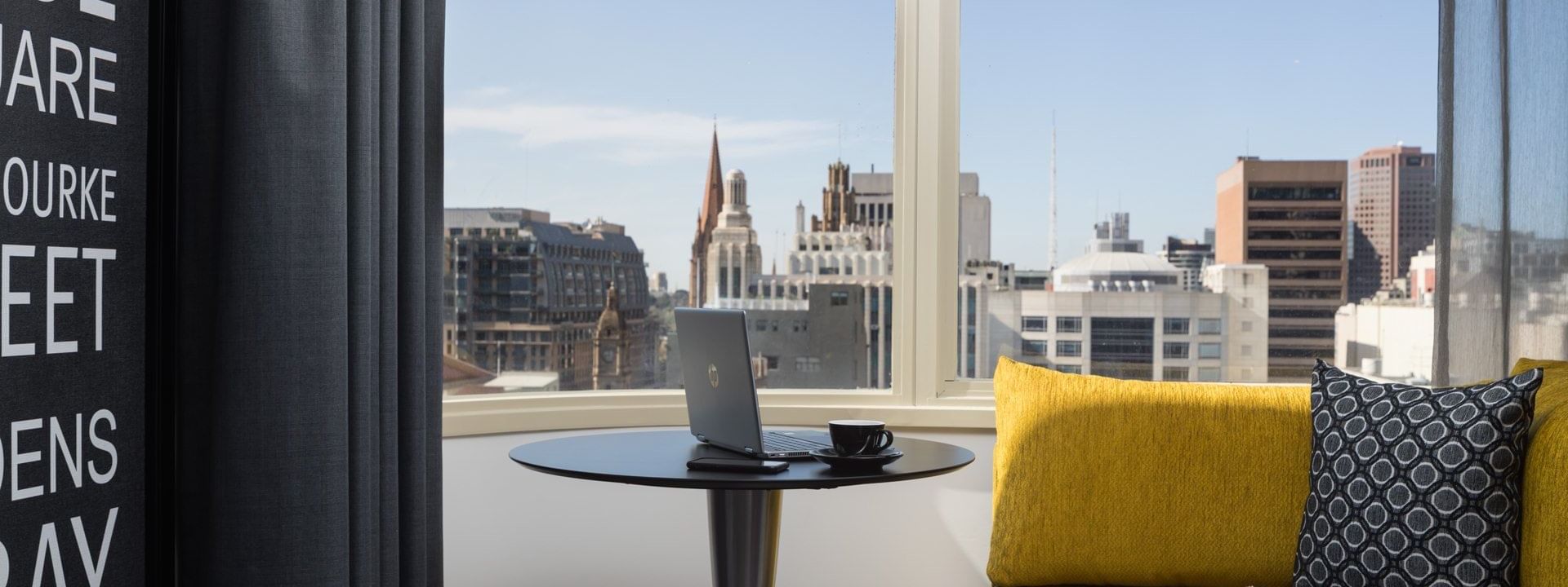 Laptop on a stool of Deluxe Room at Pullman Melbourne City