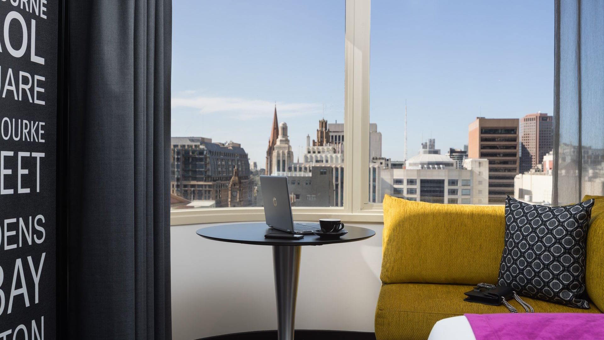 Laptop on a stool of Deluxe Room at Pullman Melbourne City