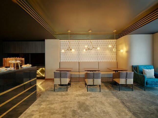 Dining tables and bar in Grand Club Double Room at GFA Hotels