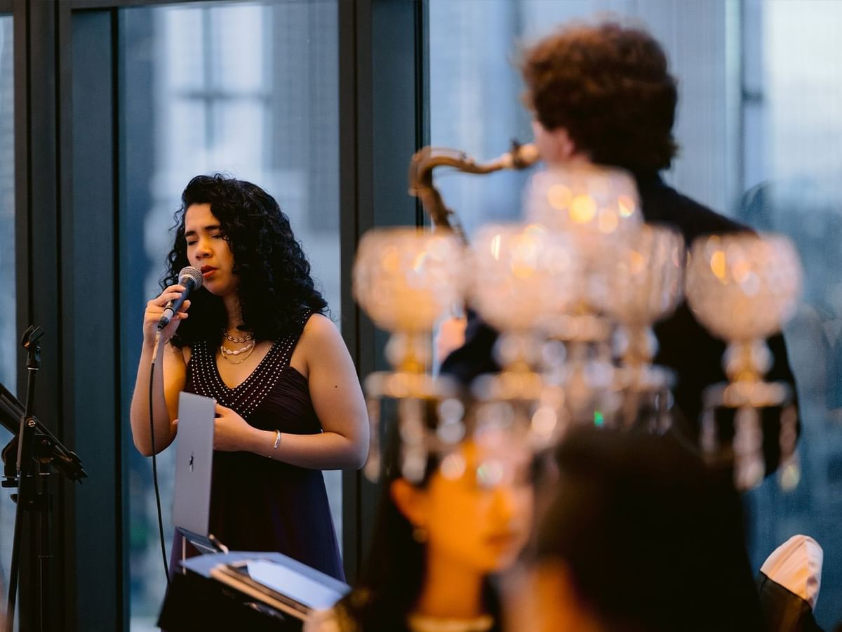 Woman singing in Felicia and Jonathan's wedding ceremony at Crown Towers Perth