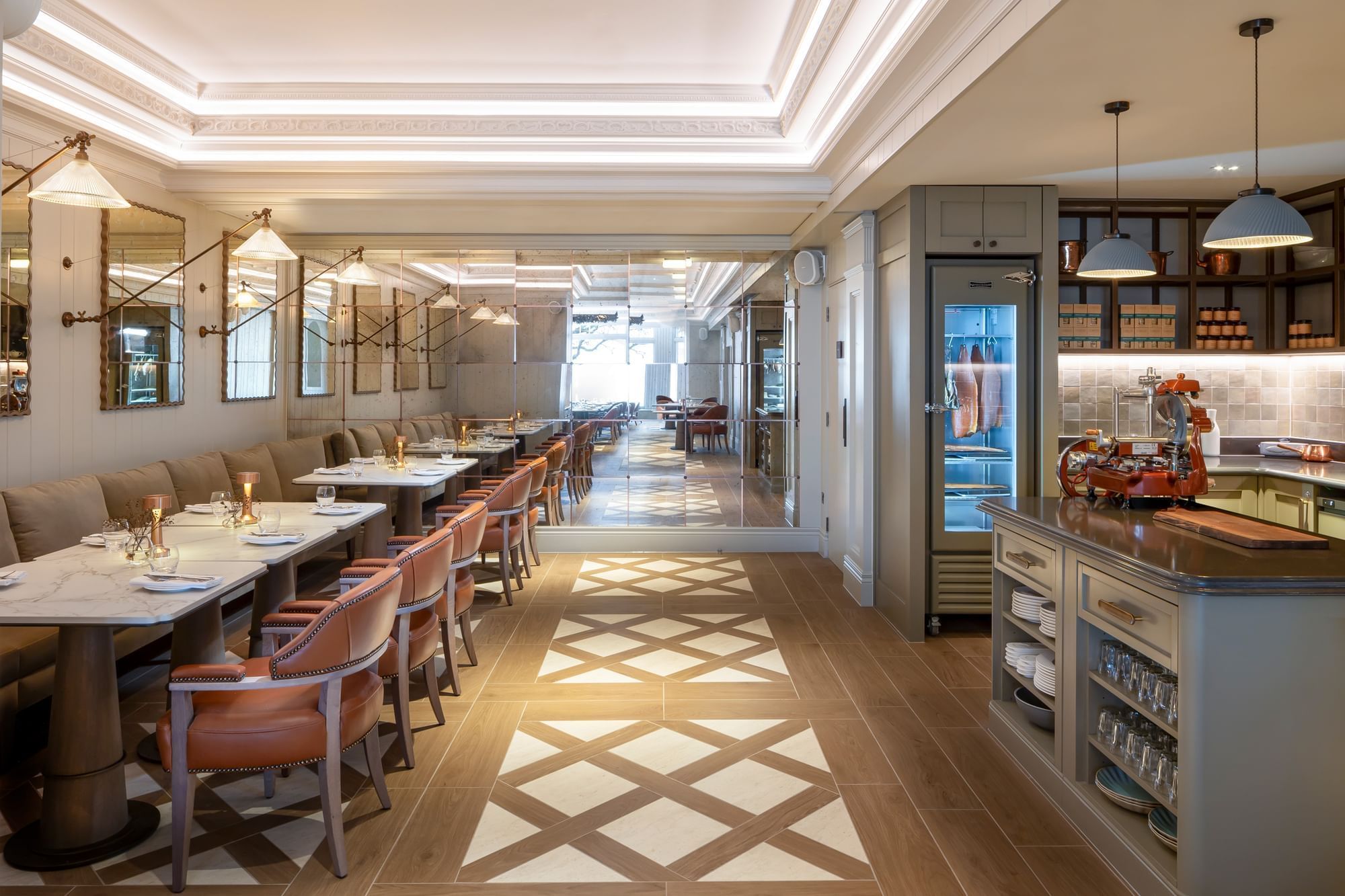The Board Room kitchen with leather chairs at tables and a mirrored wall at Seaton House
