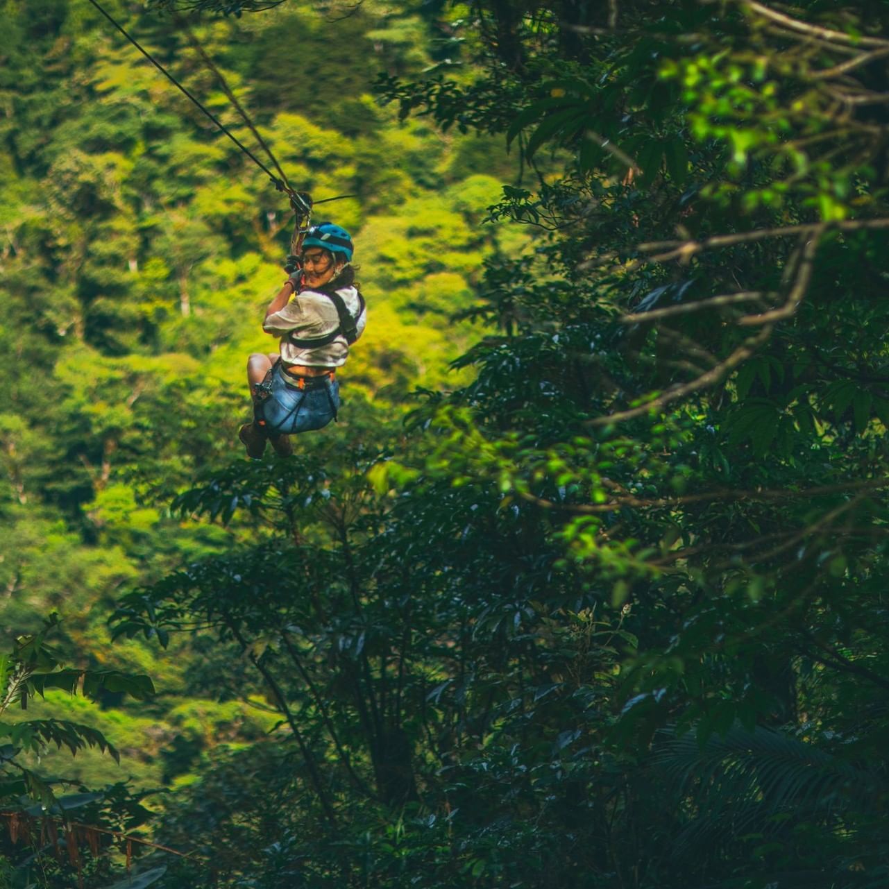 Person ziplining over Rica's Cloud Forest near El Silencio Lodge and Spa