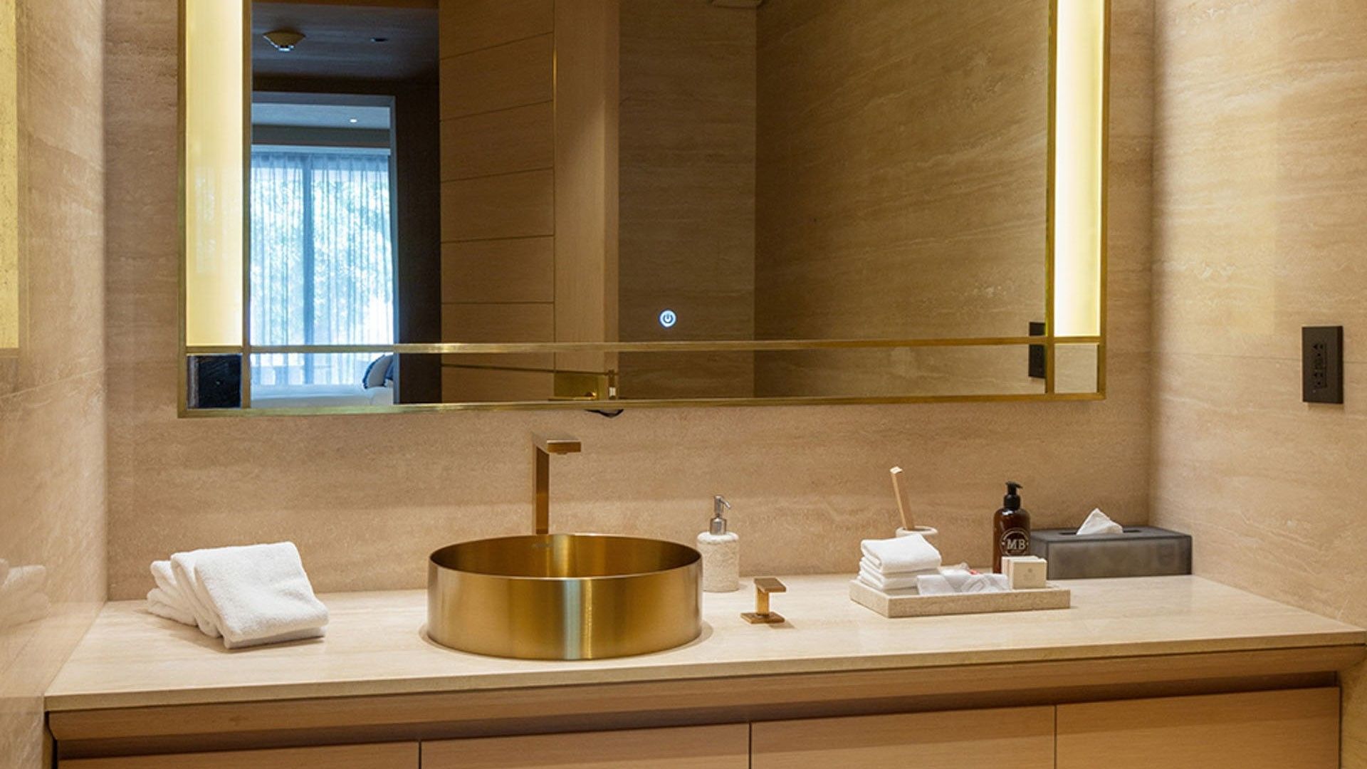 King Superior Viceroys Suite bathroom featuring a gold sink and a large illuminated mirror at Camino Real Polanco Mexico