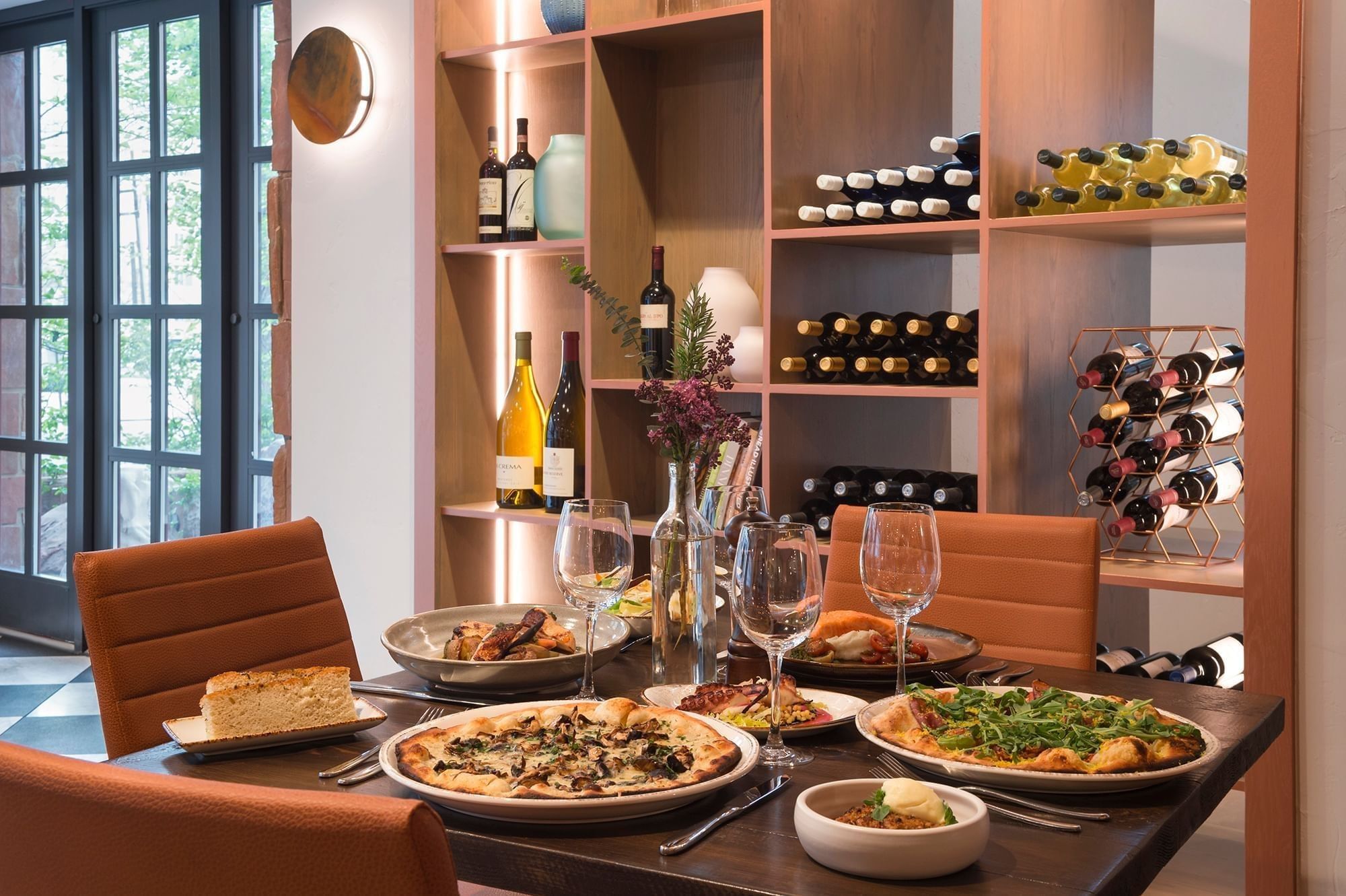 A dining table set with various dishes and wine glasses in a restaurant setting.