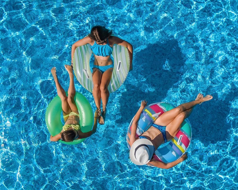 Girls relaxing on pool rings in the pool at Lake Buena Vista Resort Village & Spa