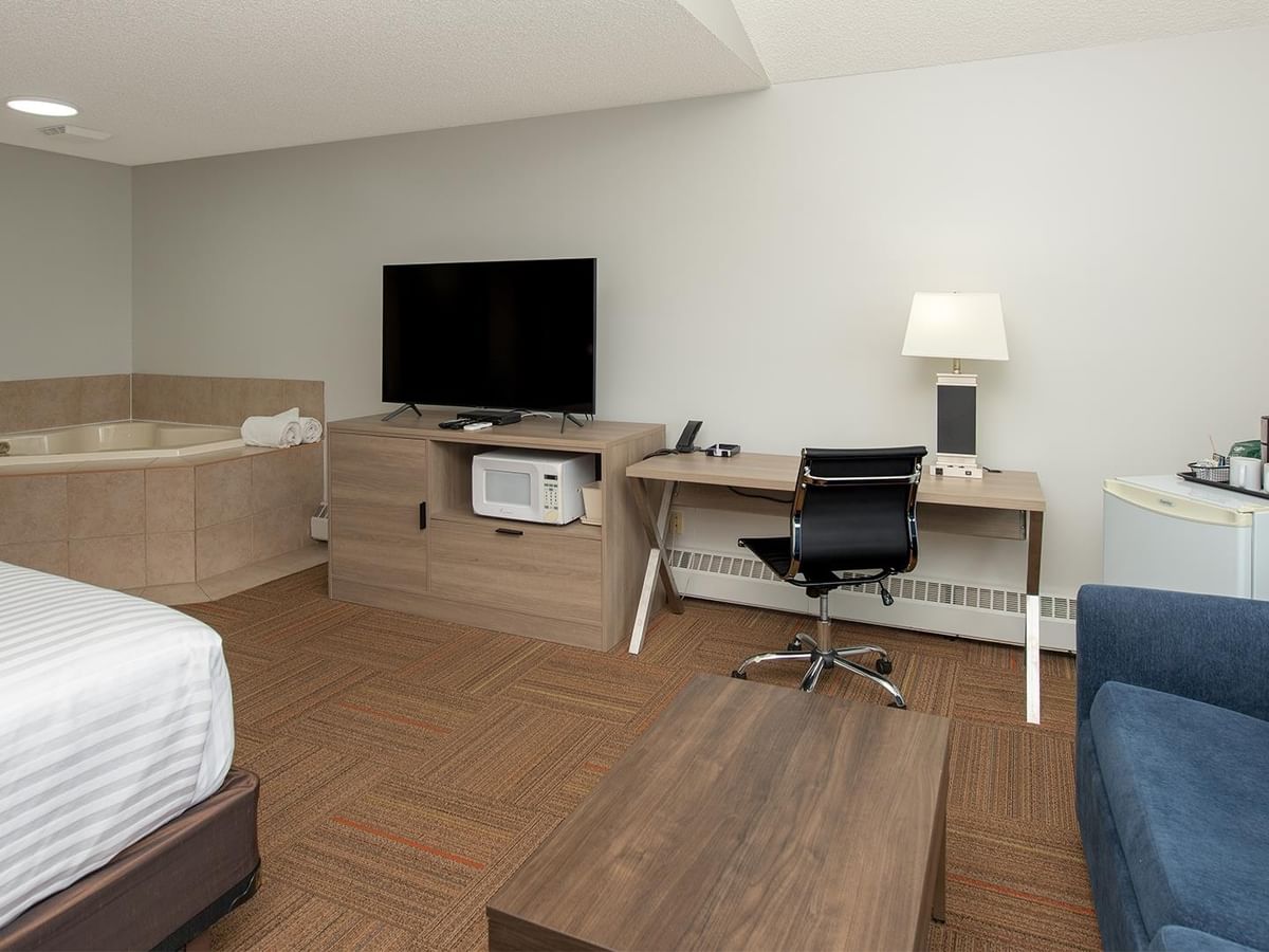 Coast Premium King Suite with Soaker Tub featuring modern furnishings and workspace.
