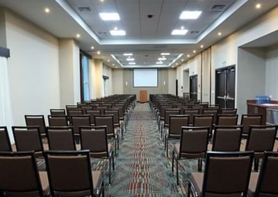 Conference room with theatre-style chair set up and projector screen at MARlNN Place Financial District, luxury hotels Panama