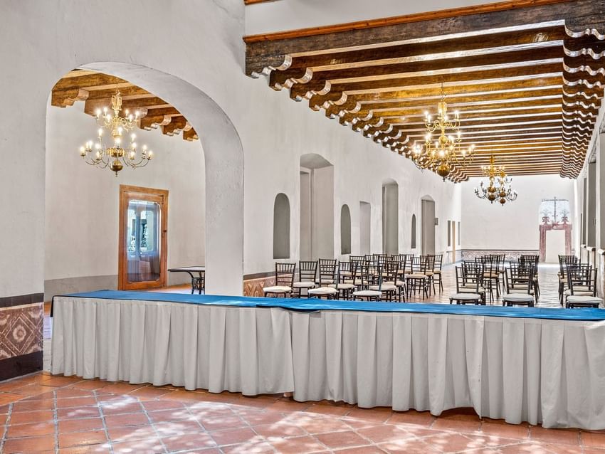 La Concepción event hall with terracotta tiles, wood-beamed ceilings, and gold chandeliers at Quinta Real Puebla