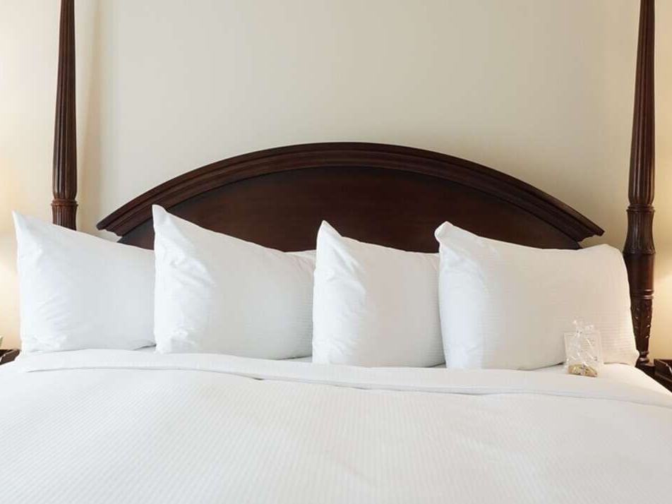 Four pillows arranged in bed view of Superior King at The Simsbury Inn
  