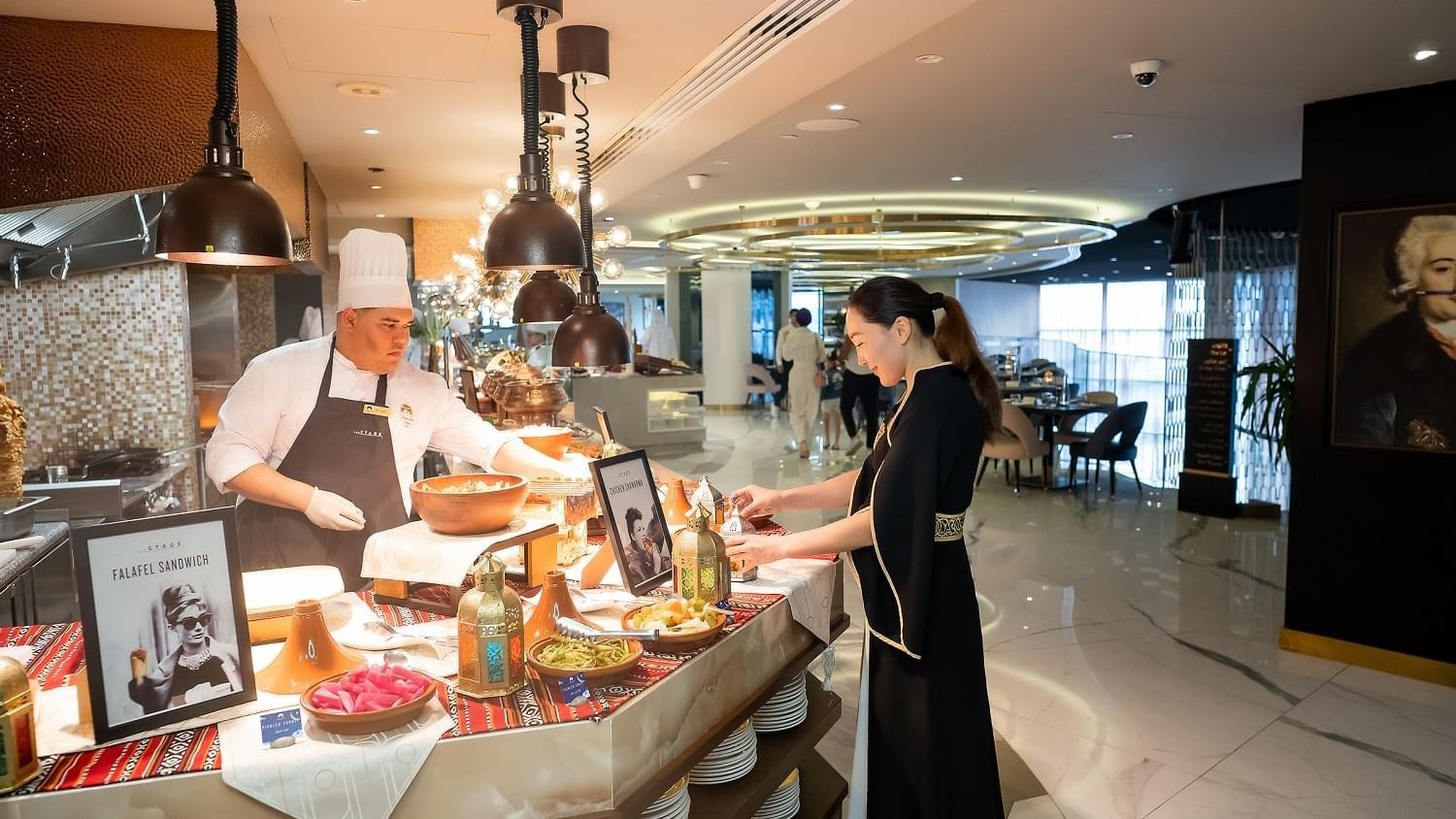 Woman by the buffet in an illuminated area Paramount Hotel Dubai