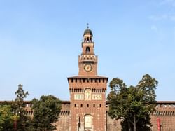 The iconic clock tower of Castello Sforzesco in Milan near Manin Hotel Milano