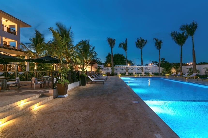Outdoor pool with sun loungers & night lights at Club Hemingway