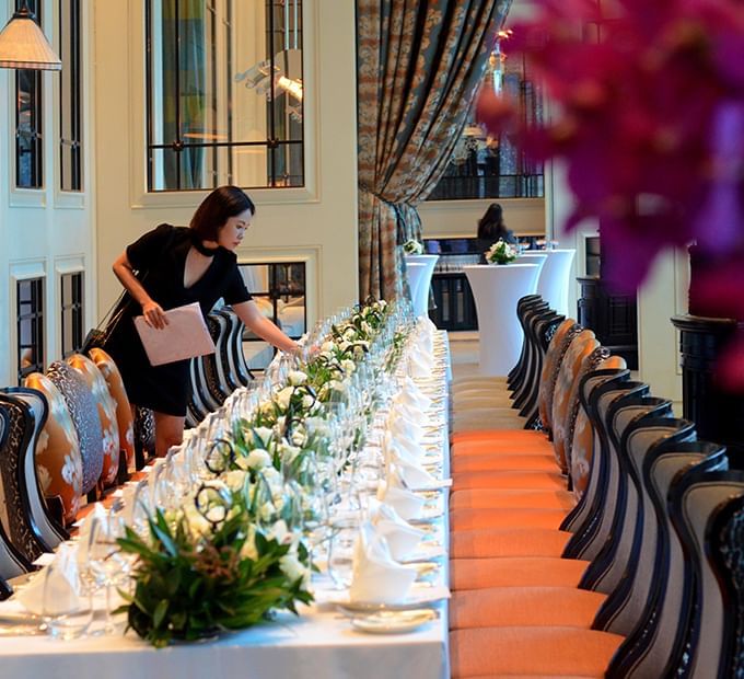 Waitress arranging tables in La Brasserie at The Fullerton Hotel Singapore