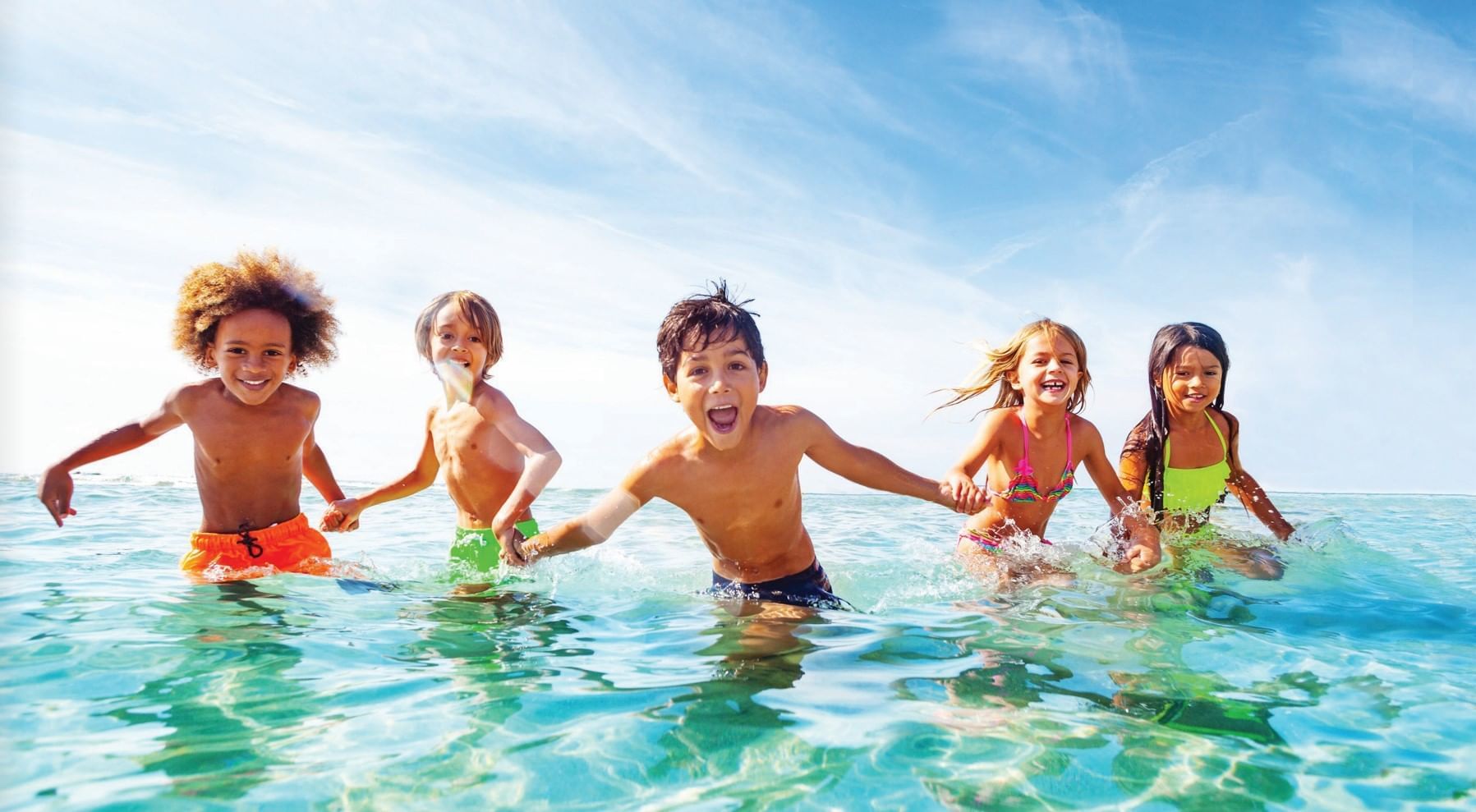 Kids holding hands on the Beach at The Diplomat Resort