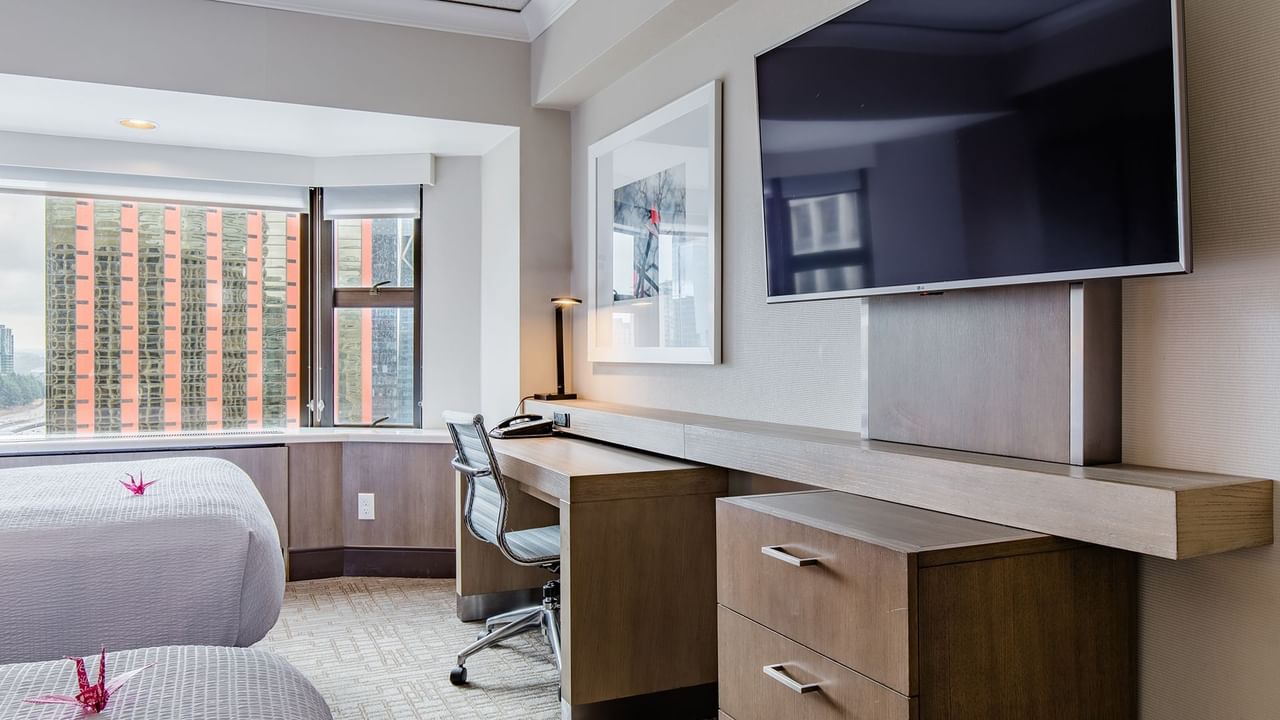 Hotel guestroom with two beds, TV and desk