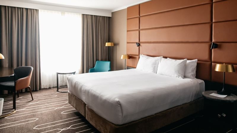 Comfortable hotel room with a large bed, modern decor, and elegant furniture showcasing The Comfort Combo.