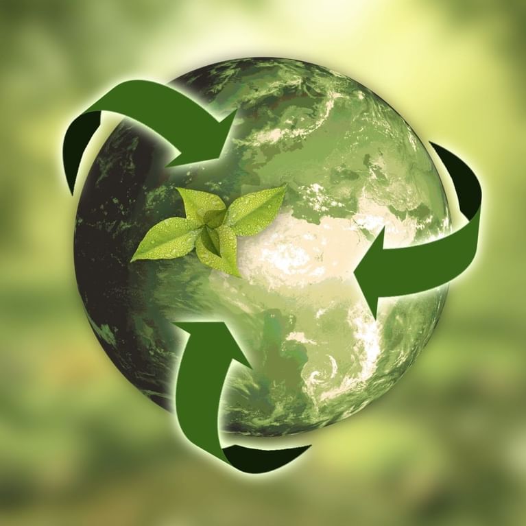 An Earth globe with a recycling symbol and a sprout image used at Titanic Hotels