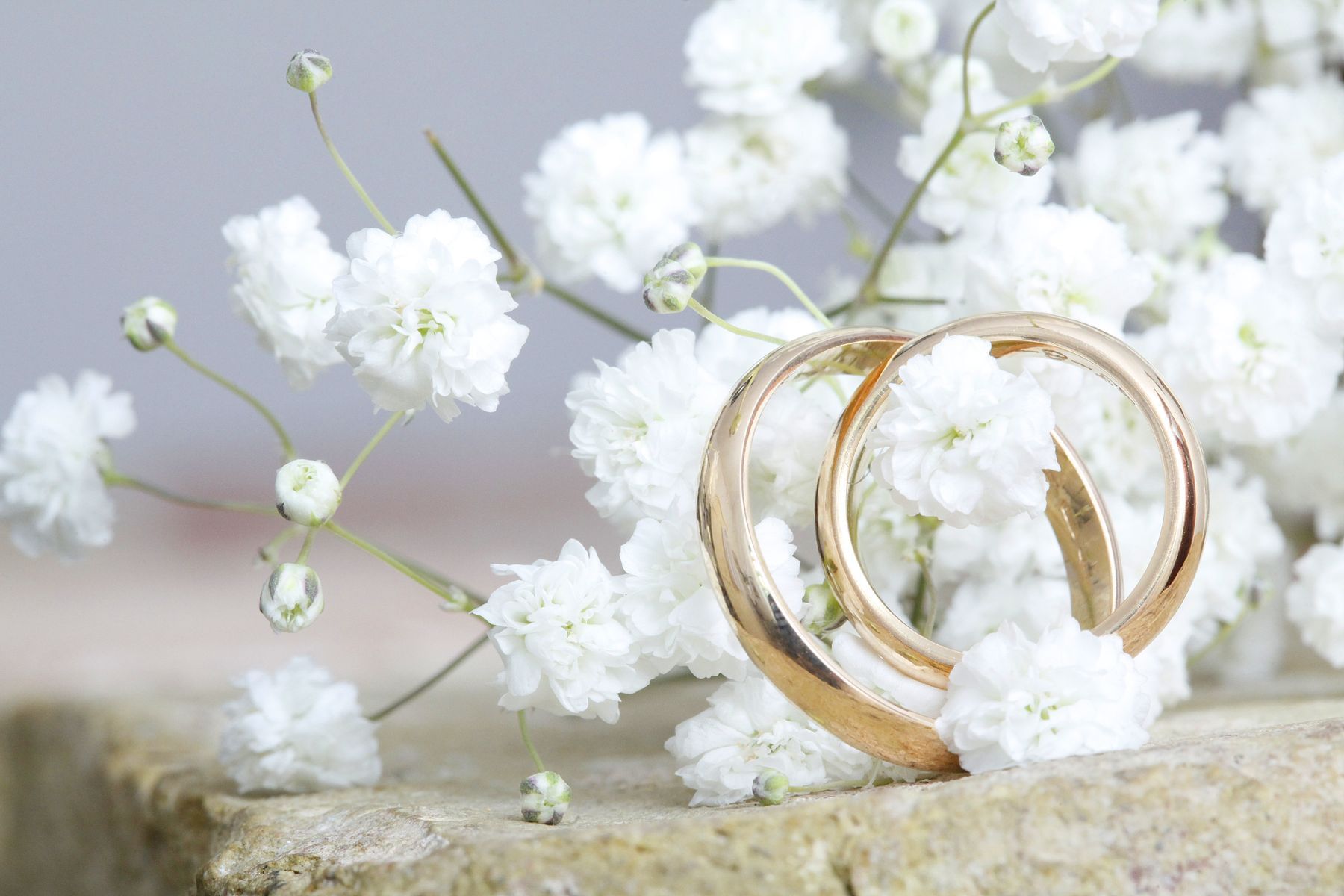 White flowers and gold rings