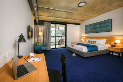 Work desk, balcony & bed in a Suite, Nesuto Curtin Perth Hotel