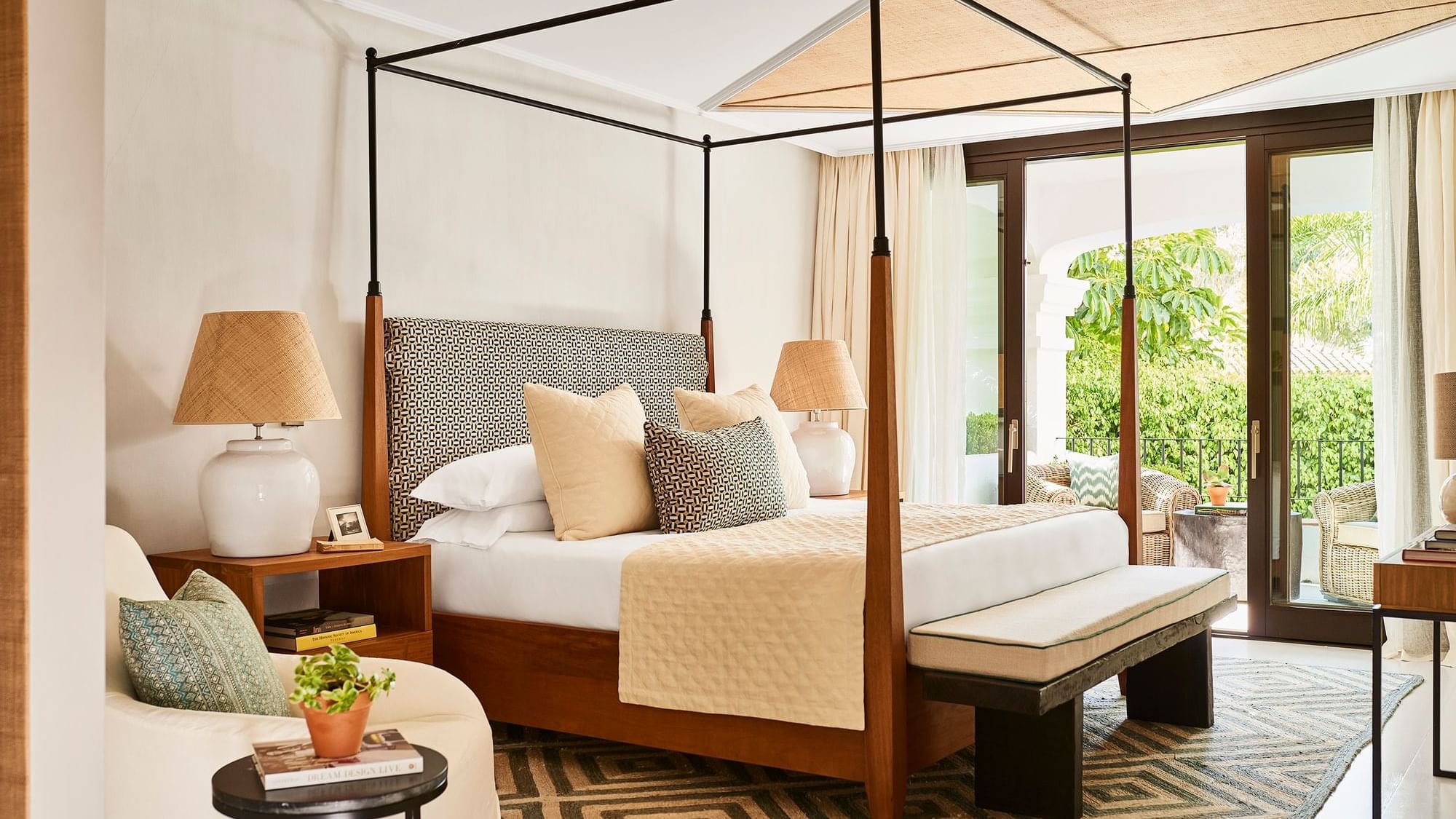 Santa Margarita Two-Bedroom Suite with a bed, headboard, geometric rug, & private terrace access at Marbella Club