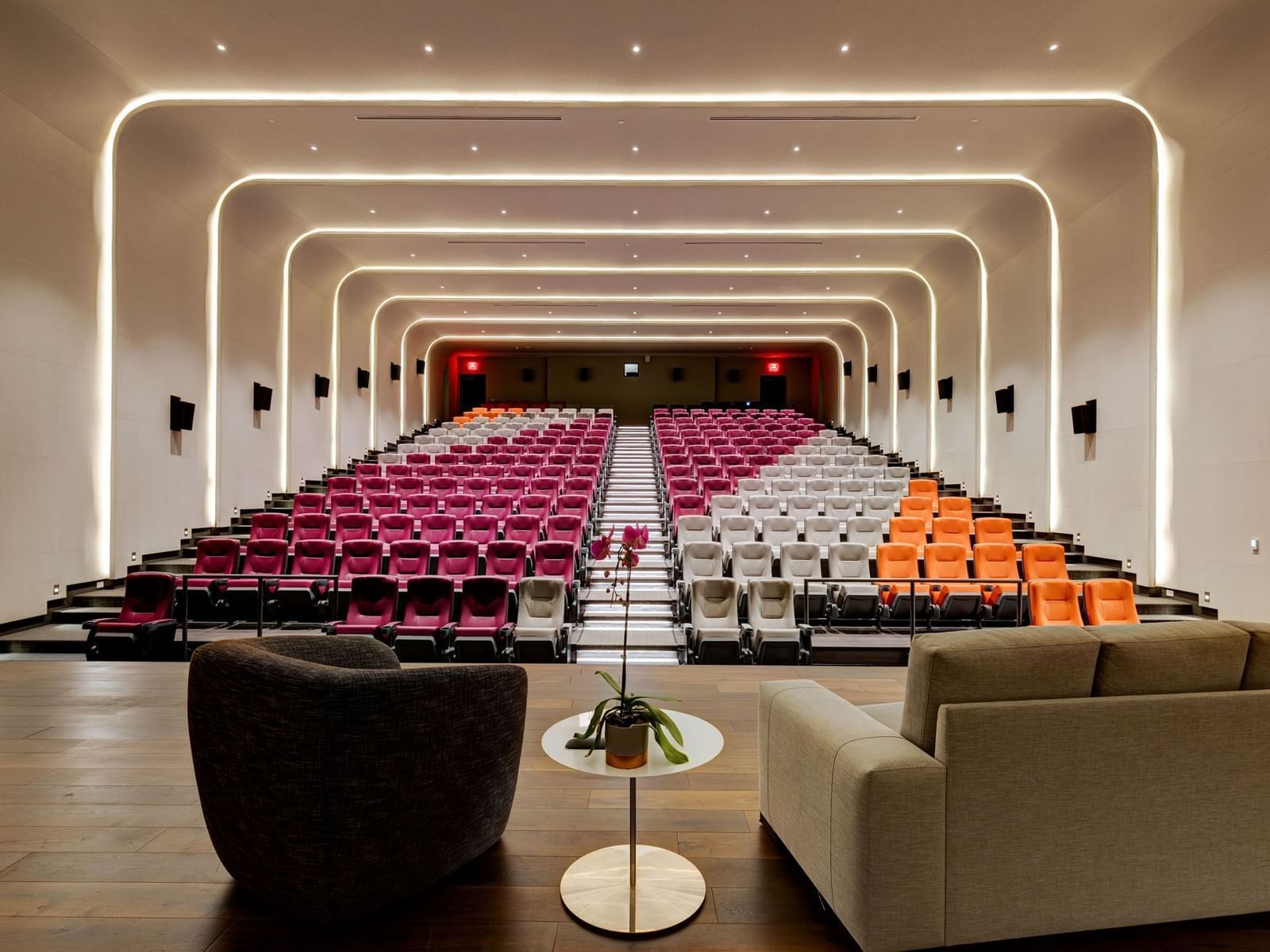HotelX Cinema auditorium with rows of chairs and stylish neon ceiling lights at Hotel X Toronto