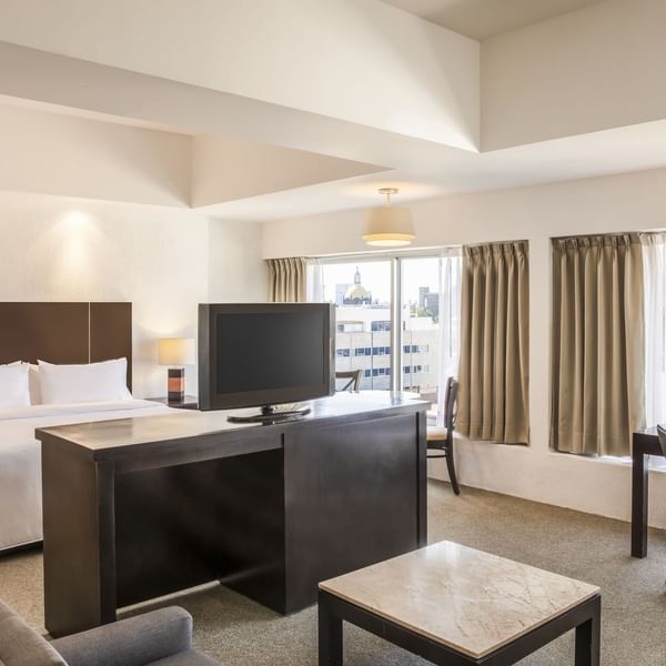 Interior of Junior king Suite with TV station at Gamma Hotels